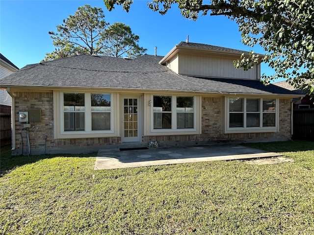 back of house with a patio and a lawn