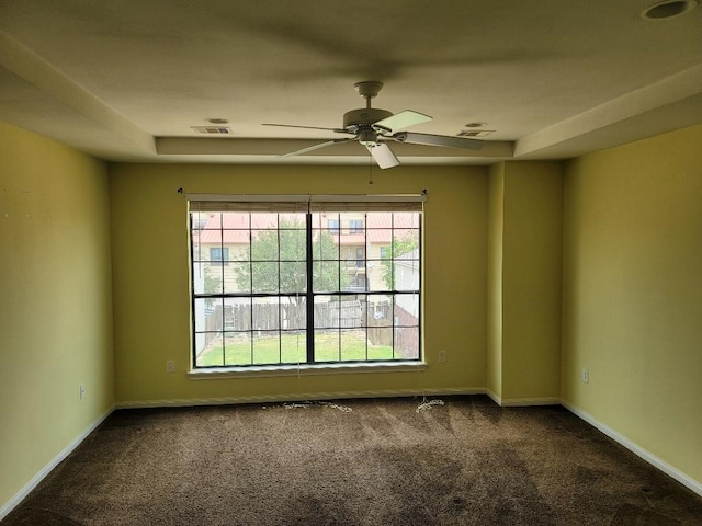 carpeted spare room featuring plenty of natural light and ceiling fan