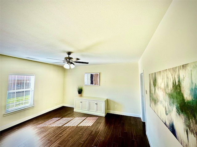 spare room featuring a textured ceiling, dark hardwood / wood-style flooring, and ceiling fan