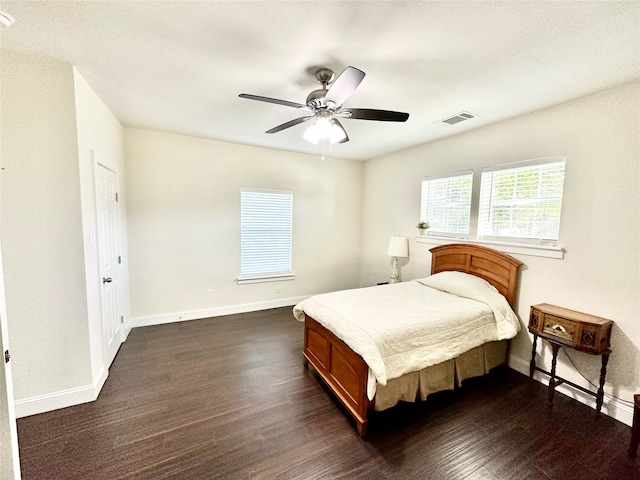 bedroom with ceiling fan and dark hardwood / wood-style floors