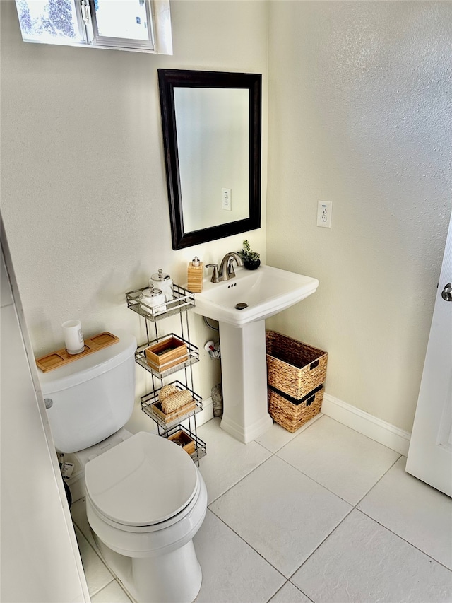 bathroom with tile patterned floors and toilet