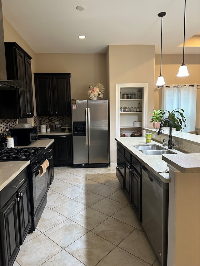 kitchen featuring sink, decorative light fixtures, black appliances, range hood, and decorative backsplash