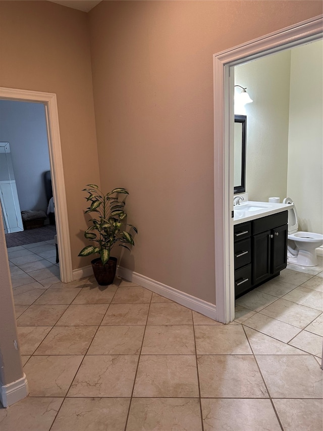 bathroom with tile patterned floors, vanity, and toilet