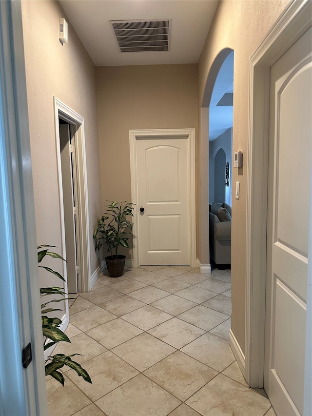 hall featuring light tile patterned flooring