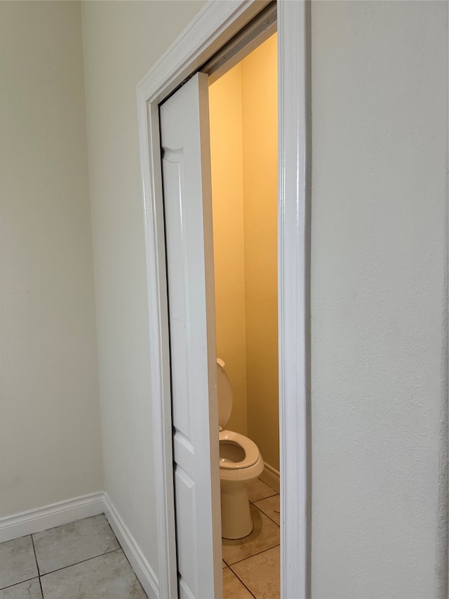 bathroom featuring toilet and tile patterned floors