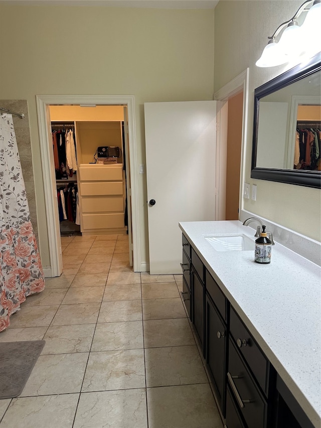 bathroom featuring vanity, tile patterned flooring, and curtained shower