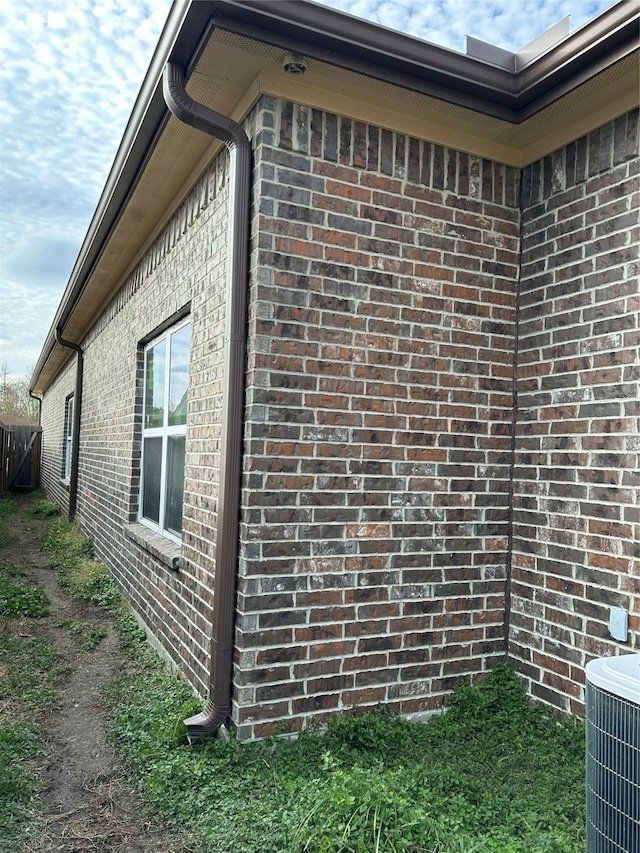 view of side of home featuring central AC unit