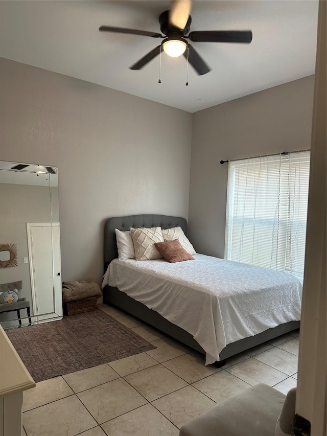bedroom with light tile patterned floors and ceiling fan