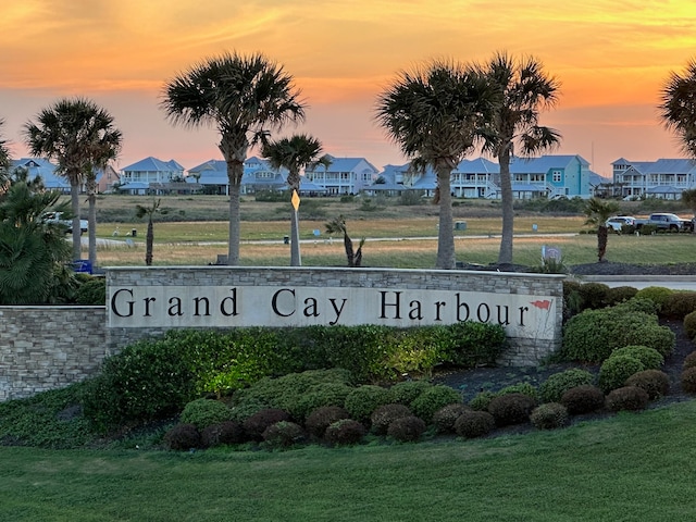 community / neighborhood sign with a yard