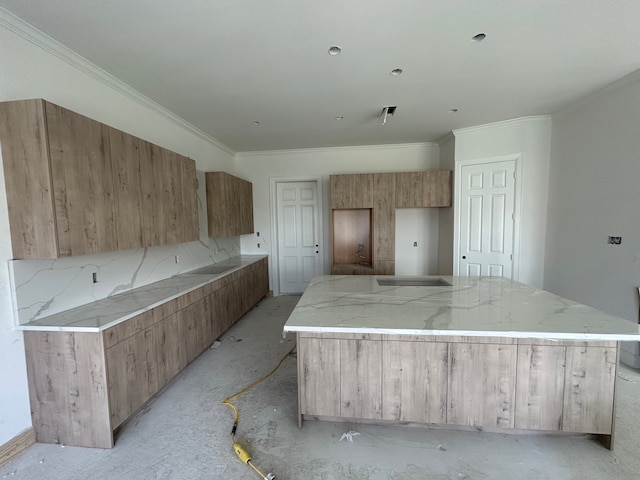 kitchen with ornamental molding, a center island, and tasteful backsplash