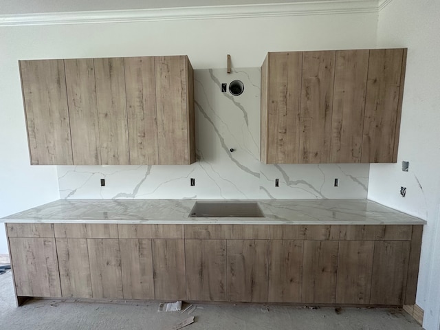 kitchen featuring crown molding and backsplash