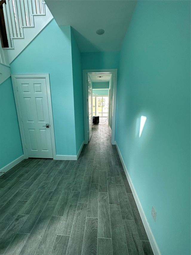 corridor with dark hardwood / wood-style floors