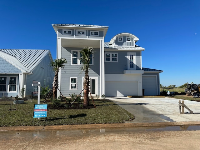 view of front of property with a garage and a front yard