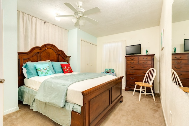 bedroom featuring a closet, ceiling fan, and light colored carpet