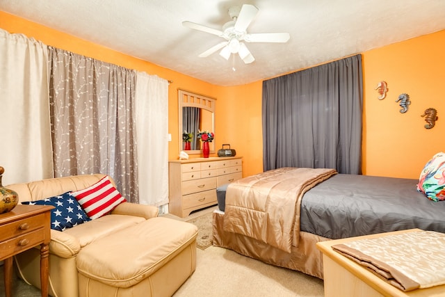 bedroom with carpet, a textured ceiling, and ceiling fan