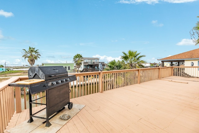 wooden deck with grilling area and a water view