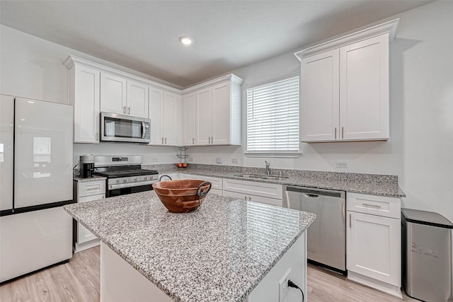 kitchen featuring white cabinets, stainless steel appliances, and a center island