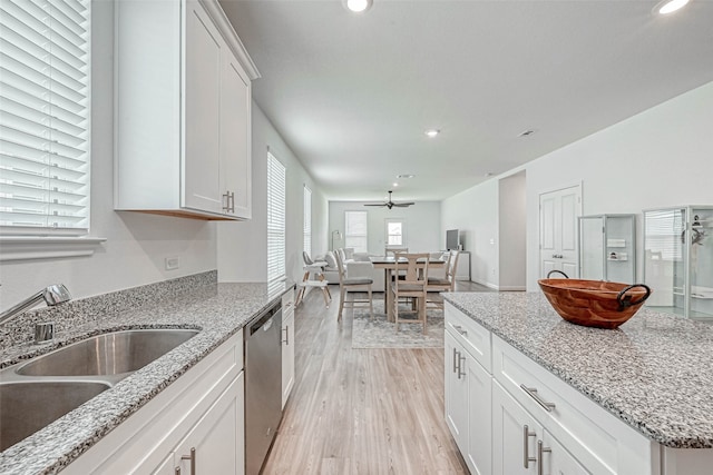 kitchen with white cabinetry, dishwasher, ceiling fan, light hardwood / wood-style flooring, and sink