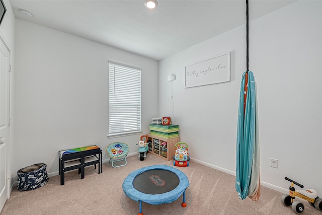 game room featuring light colored carpet