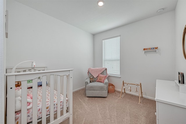 carpeted bedroom with a crib