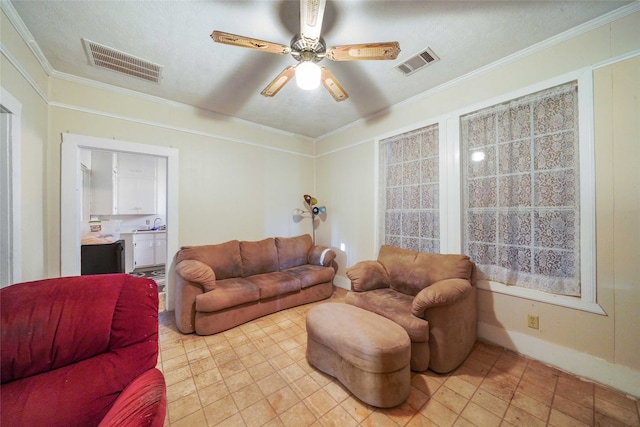 living room featuring a textured ceiling, crown molding, and ceiling fan