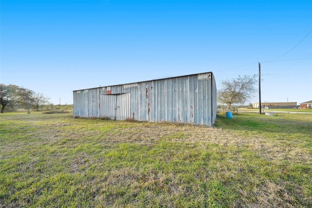 view of outbuilding with a yard