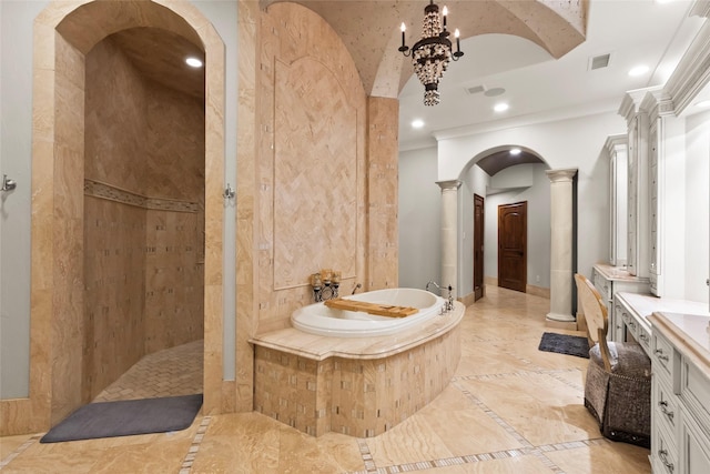 bathroom with ornate columns, vanity, and shower with separate bathtub