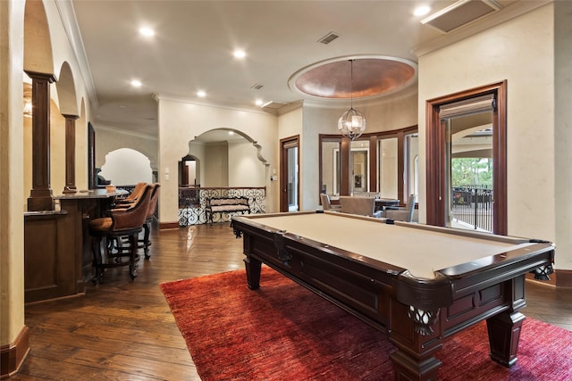 recreation room with dark hardwood / wood-style floors, ornamental molding, pool table, and an inviting chandelier