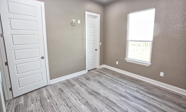 unfurnished bedroom with light wood-type flooring