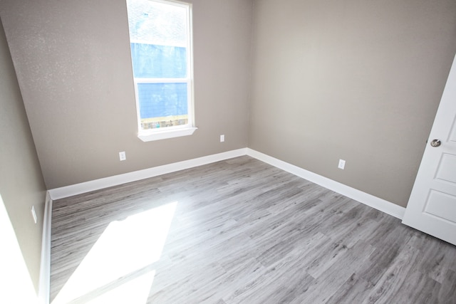 unfurnished room with light hardwood / wood-style floors