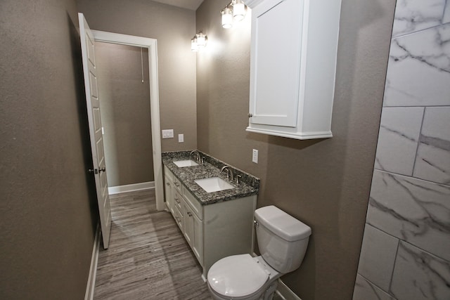 bathroom with vanity, toilet, and hardwood / wood-style flooring