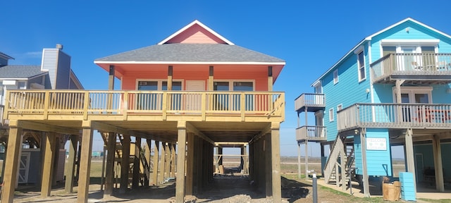 rear view of house with a balcony and a carport