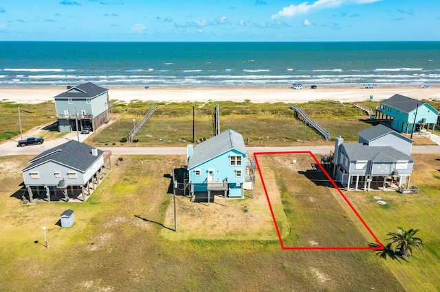 bird's eye view featuring a view of the beach and a water view