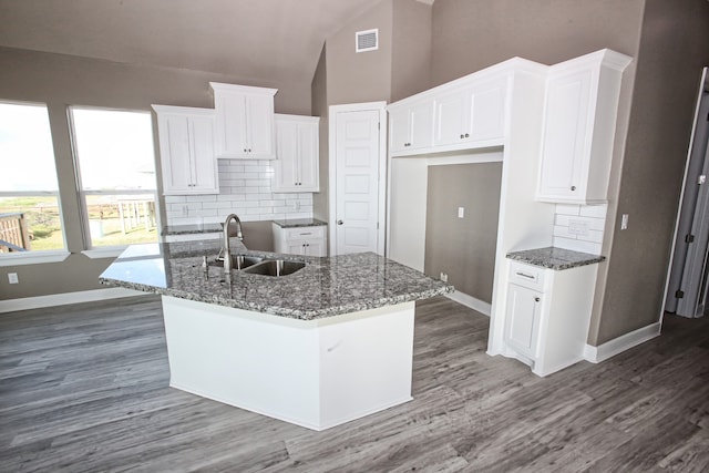 kitchen featuring white cabinetry, high vaulted ceiling, a kitchen island with sink, dark hardwood / wood-style floors, and sink