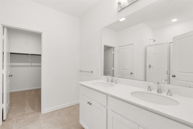 bathroom with double vanity and tile patterned flooring