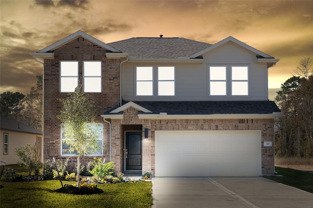 view of front of property featuring a yard and a garage