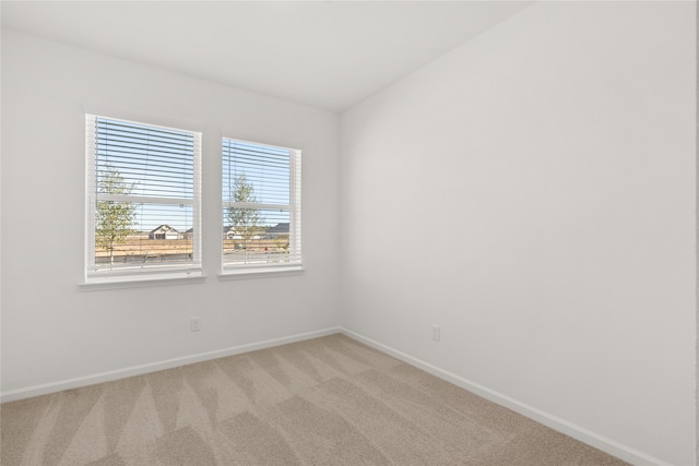 carpeted empty room with a wealth of natural light