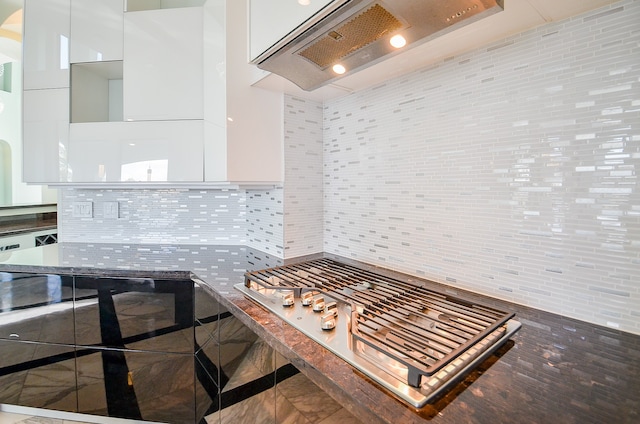 kitchen featuring white cabinetry, custom exhaust hood, and backsplash