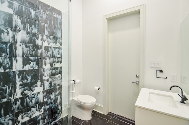 bathroom with toilet, vanity with extensive cabinet space, and tile flooring