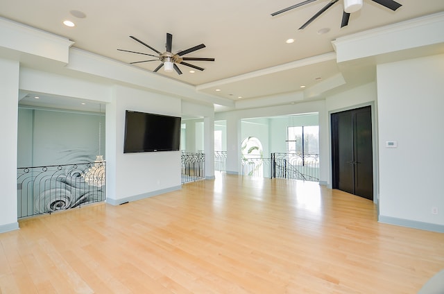 living room featuring ornamental molding, ceiling fan, and light wood-type flooring