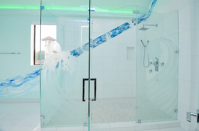 bathroom featuring an enclosed shower and tile floors