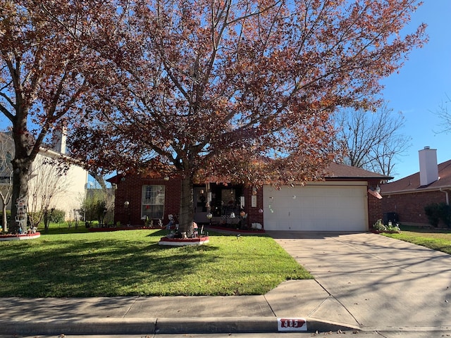 view of property hidden behind natural elements featuring a front yard and a garage