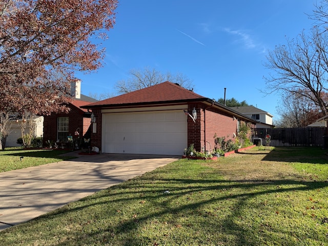 single story home featuring a front lawn and a garage