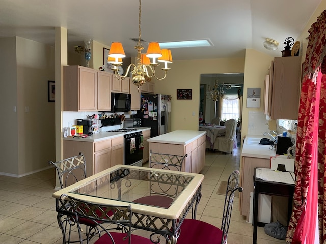 kitchen featuring light tile floors, decorative light fixtures, white range with gas stovetop, stainless steel refrigerator with ice dispenser, and an inviting chandelier