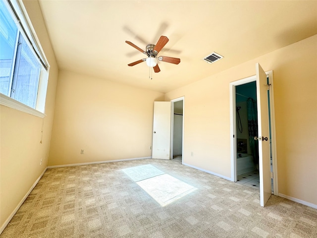 unfurnished bedroom with light carpet and ceiling fan