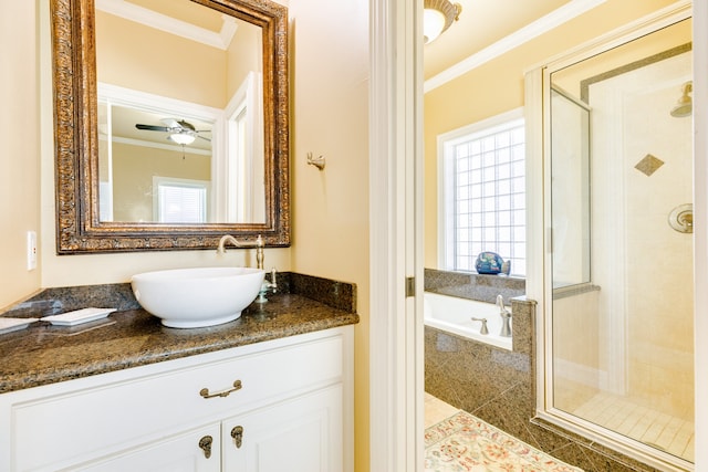 bathroom with a wealth of natural light, ceiling fan, vanity, and crown molding