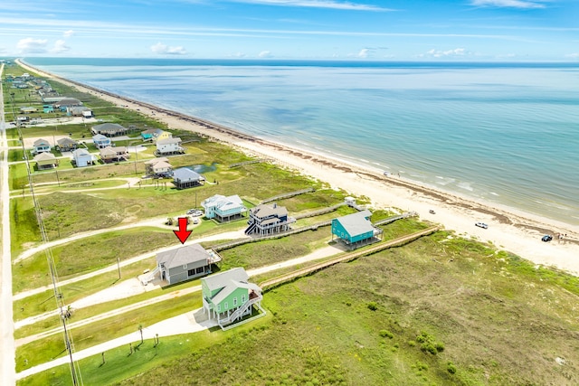 bird's eye view with a water view and a beach view