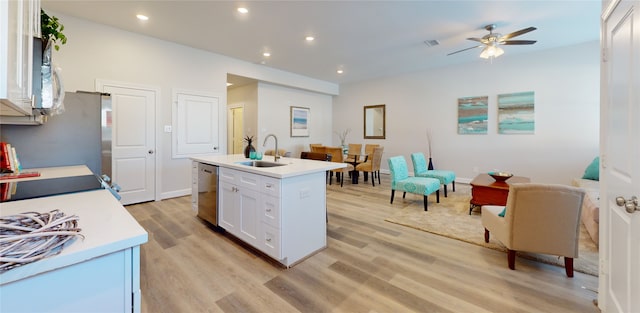 kitchen featuring ceiling fan, light hardwood / wood-style flooring, white cabinets, a kitchen island with sink, and sink