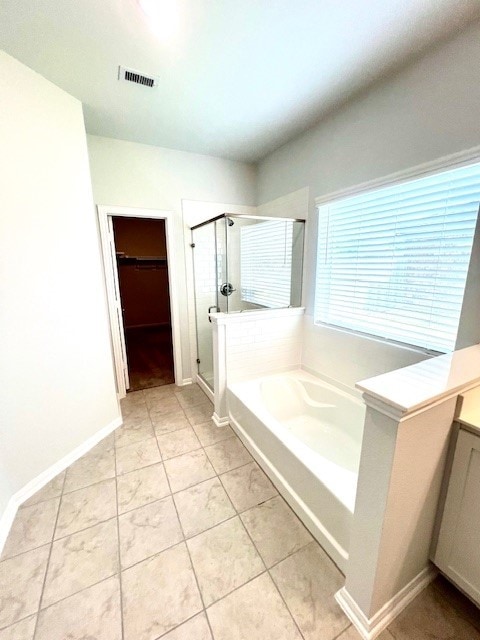 bathroom featuring a garden tub, visible vents, a spacious closet, a shower stall, and tile patterned floors