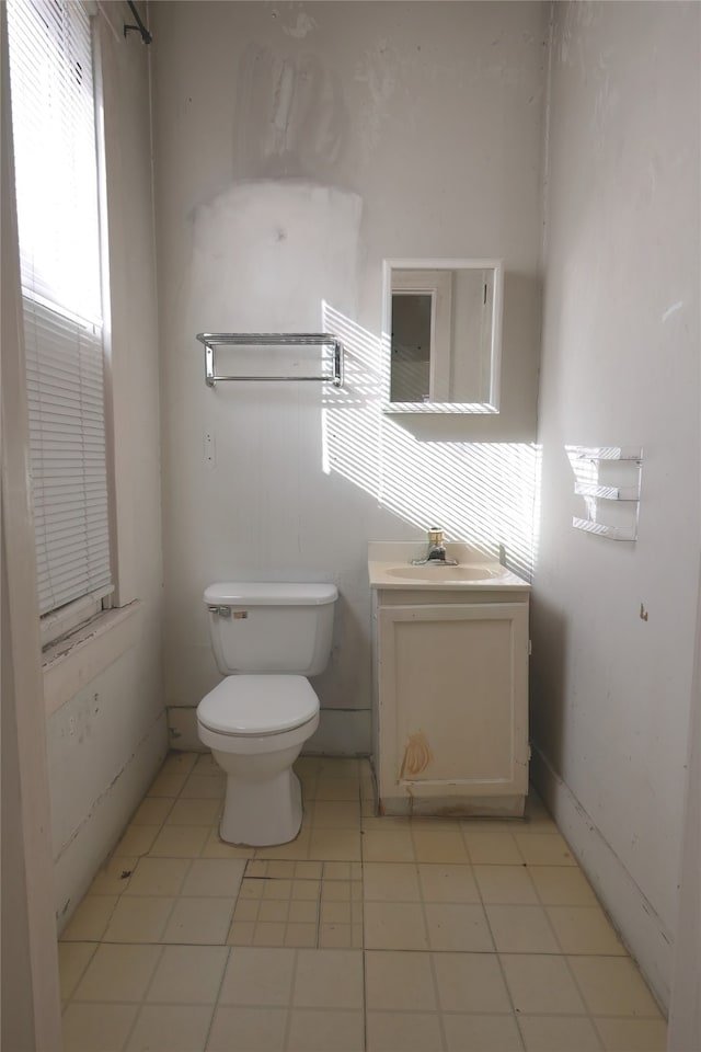 bathroom featuring toilet, vanity, and tile patterned flooring